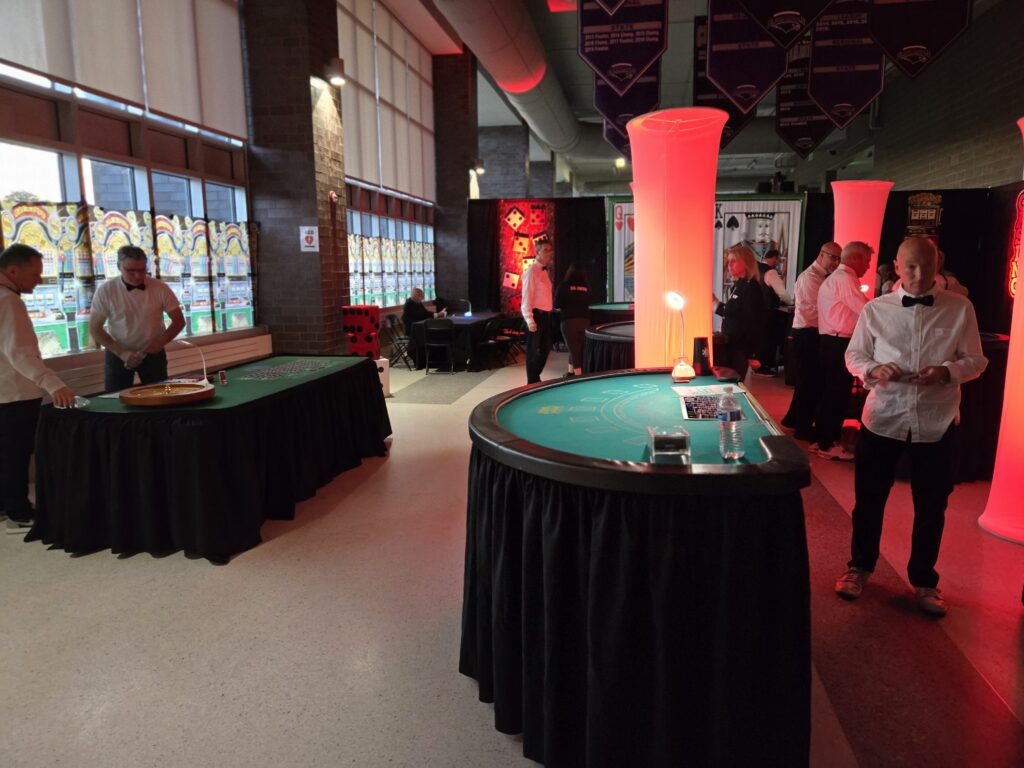 Casino event with gaming tables and staff.